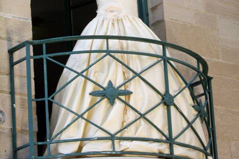 Bride on balcony on mansion during outdoor wedding at Concordia College in Ann Arbor