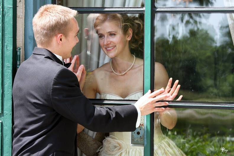 Bride on balcony on mansion during outdoor wedding at Concordia College in Ann Arbor