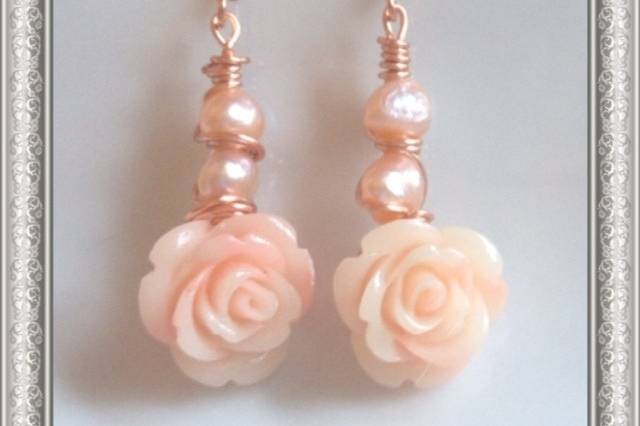 Earrings designed and created by Mystic Angel Creations. Materials used: artisan grade, nontarnishable wire, fresh water pearls and coral flowers