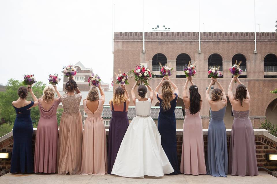 Bridal party holding up their flowers