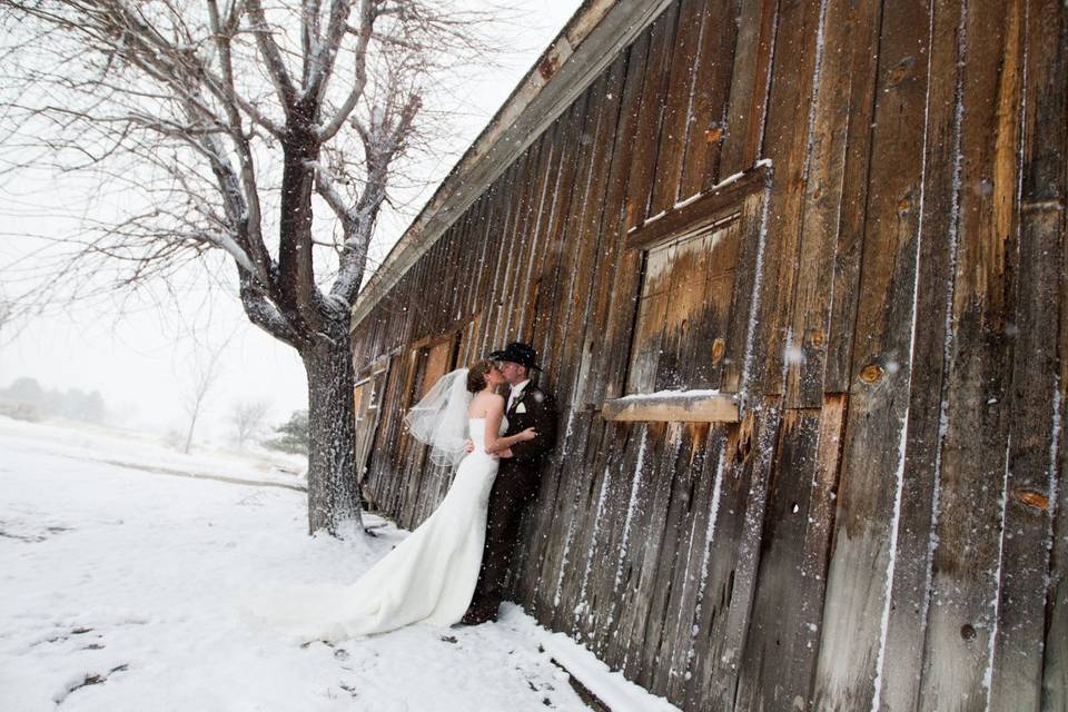 Couple kiss by the barn