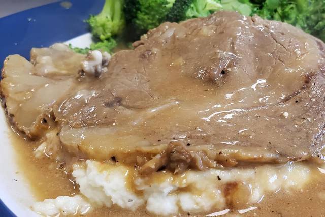 Sliced Beef over potatoes