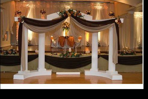 We carry Colonnades to set up your stage. Can be set up with any colors of linens and flower arrangement.