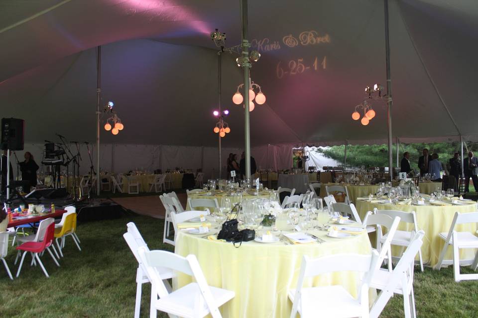 Interior of 60' x 70' century pole tent with extensive colored uplighting.