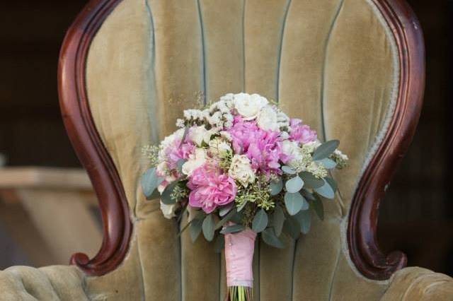 Pink And Beige Wedding Bouquet Is Sitting On Top Of A Sofa