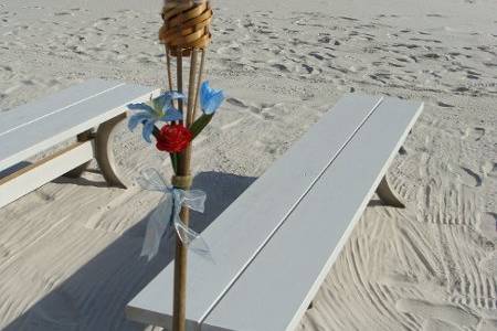 Details of flowers and ribbon add to the romance of a beach wedding.