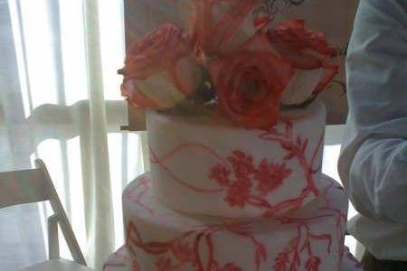 A White Fondant Three Tiered Vanilla Pound Cake with Fresh Roses to match.Hand Painted Cakes are something we exclusively do and are custom designed for you the lovely couple.Moderately Priced.