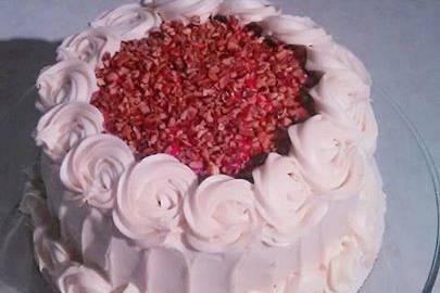 Red Velvet Cake with cream cheese frosting and pecan topping.