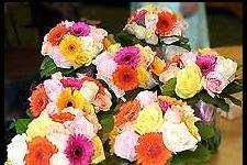 Fresh bridesmaid bouquets of colorful gerbera daisies and roses.