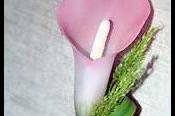 A festive, faux calla lily buttonhole boutonnierre for a dapper groom.