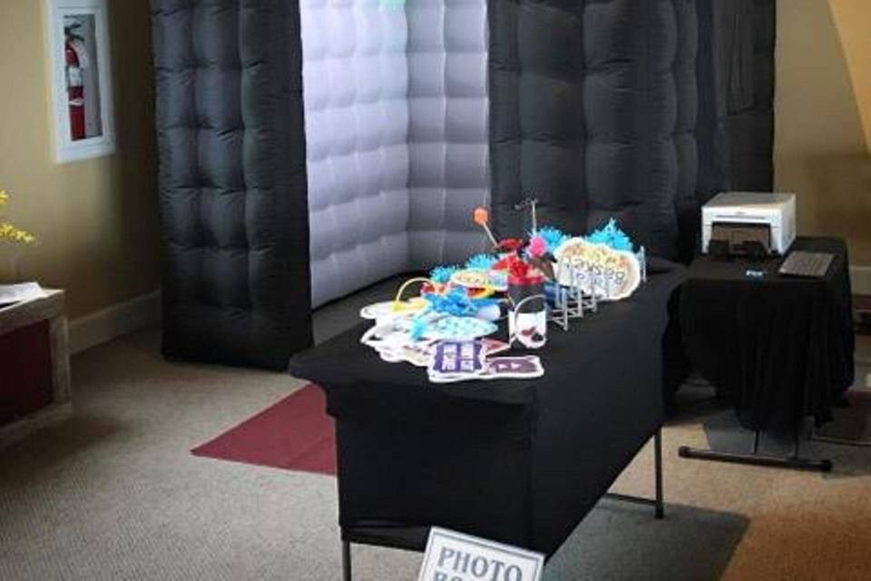 Inflatable photo booth with LED lights inside. With the flap lowered, it becomes enclosed.