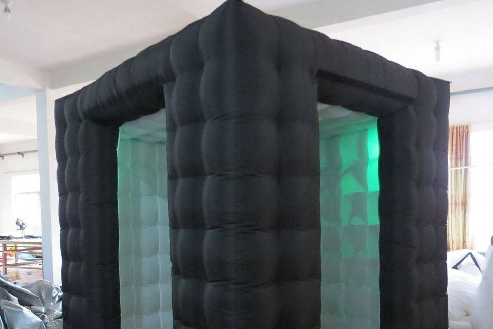 Inflatable photo booth with LED lights inside. With the flap lowered, it becomes enclosed.