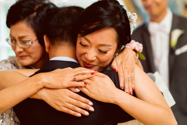A family hugs the bride