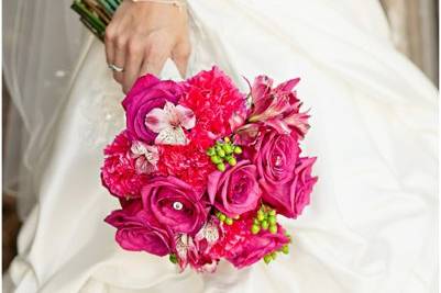 Pink brides bouquet of roses, alstroemeria, carnations and hypericum berries.