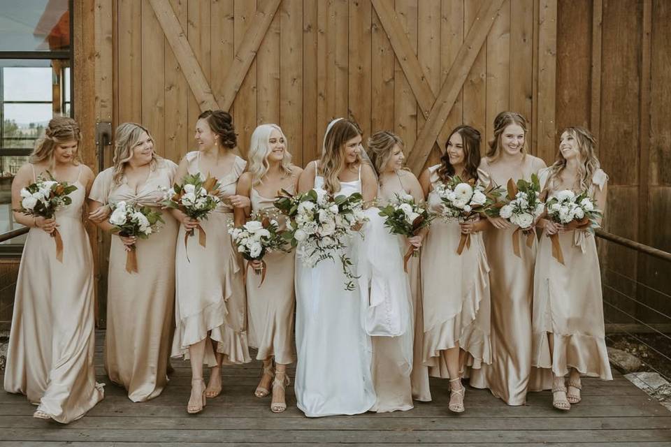 Bridesmaids in front of barn