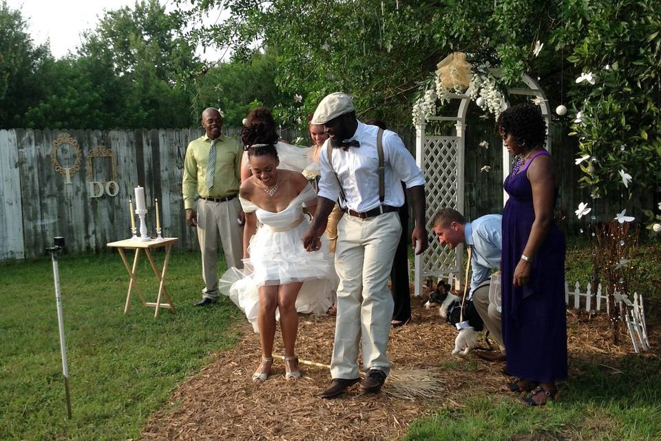 The newlyweds jump the broom