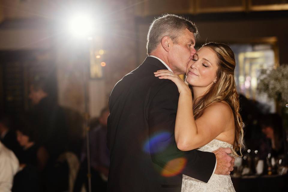 Groom kissing his wife on their wedding dance