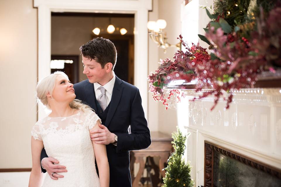 Newlyweds embracing under chandelier