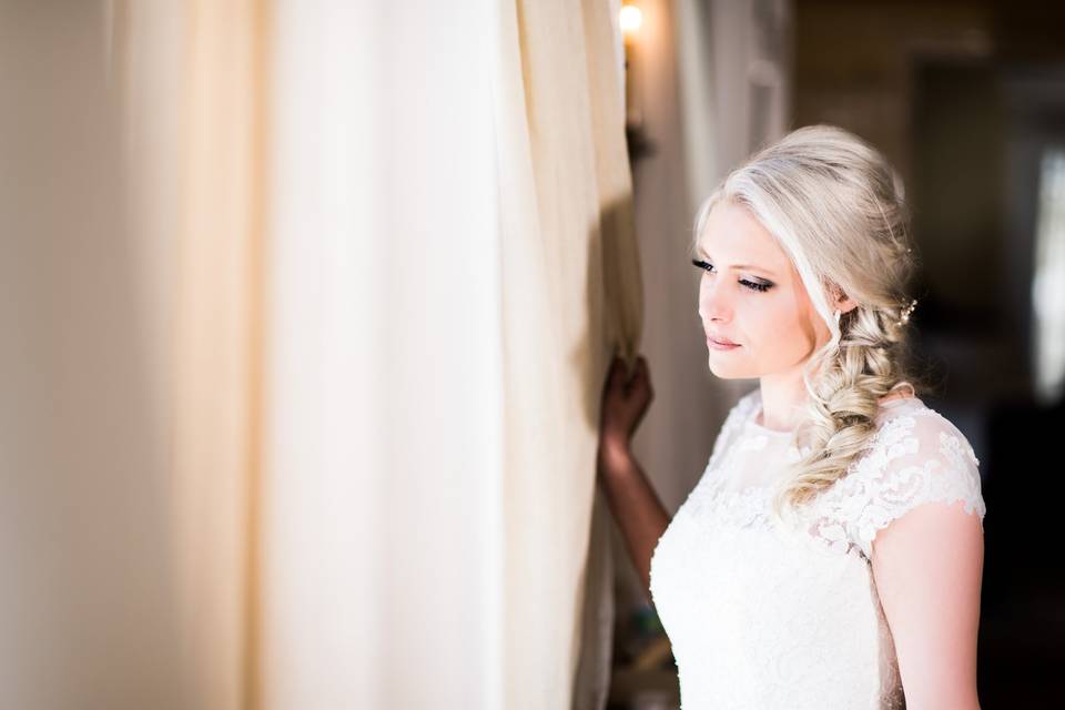 Bride gazing through the window