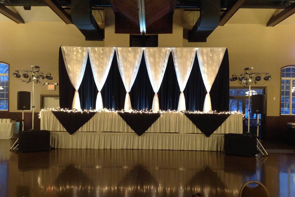 Classy head table with lighting and draping