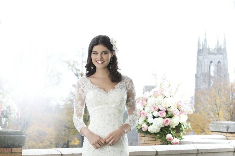 Preview 2014
Style 3759
The fit and flare beaded lace and tulle gown has an elegant V-neckline and three quarter length sleeves. The back of the bodice and chapel length train are embellished by satin buttons and lace appliques.