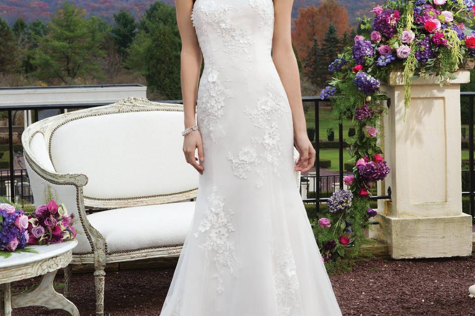 Style # 3815
Beaded and embroidered fit and flare gown featuring satin laser cut flowers over tulle and a soft sweetheart neckline. The gown is finished with a sized grosgrain detachable belt, satin covered buttons over the back zipper and a chapel length train.