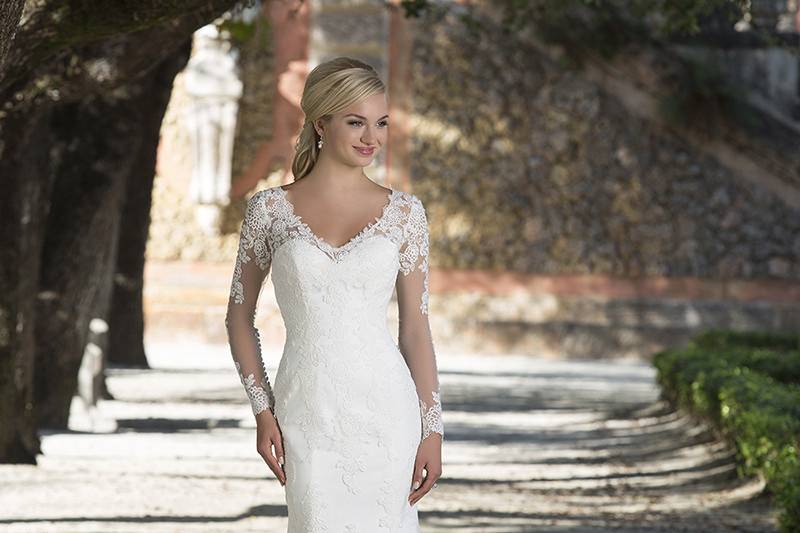 Style 3898 <br> Illusion lace and tulle long sleeve fit and flare gown featuring a V-neckline with floating lace and a scalloped hem create this graceful gown.
