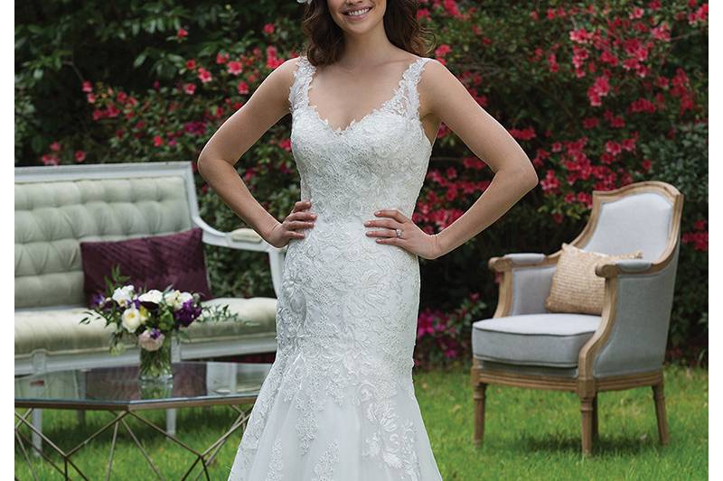 3955 <br> From the illusion sequin straps to the sequin appliques on the chapel length train, this gown exudes beauty. For even more charm, add self-tie belt style 3955B.