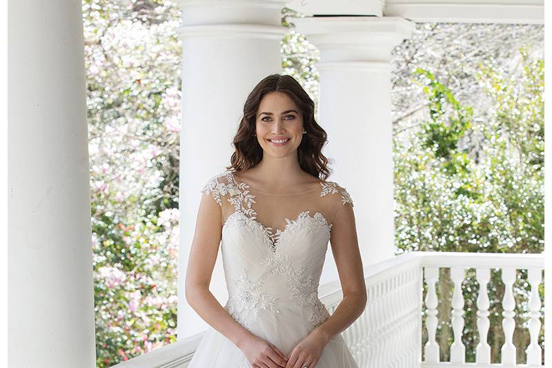 3968 <br> The perfect touch of lace adorns this tulle ball gown with an illusion Sabrina neckline, natural waist, tiered skirt, and chapel length train.