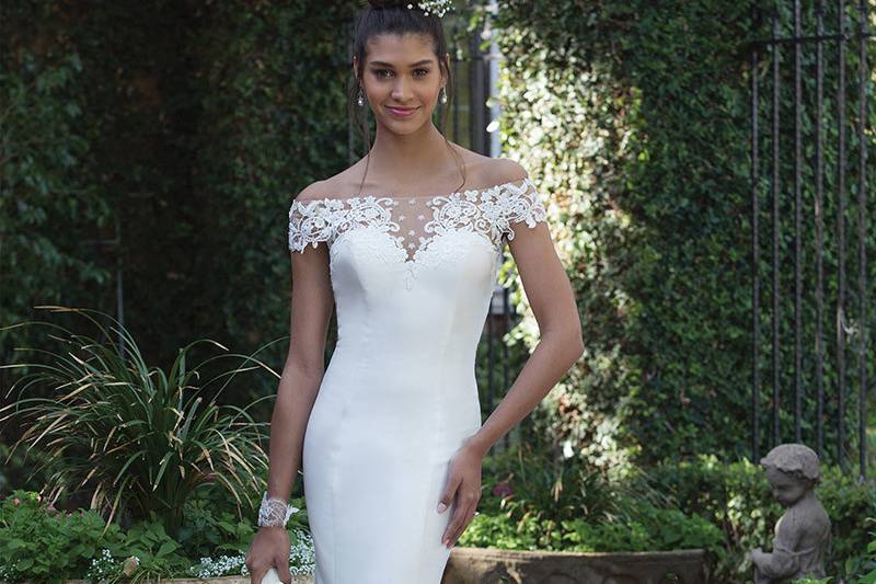 Sincerity Bridal	4010	<br>	Venice lace accents the illusion panels of this off the shoulder fit and flare with hand placed lace accenting the deep V-back. Buttons finish the look down to the bottom of the zipper closure.