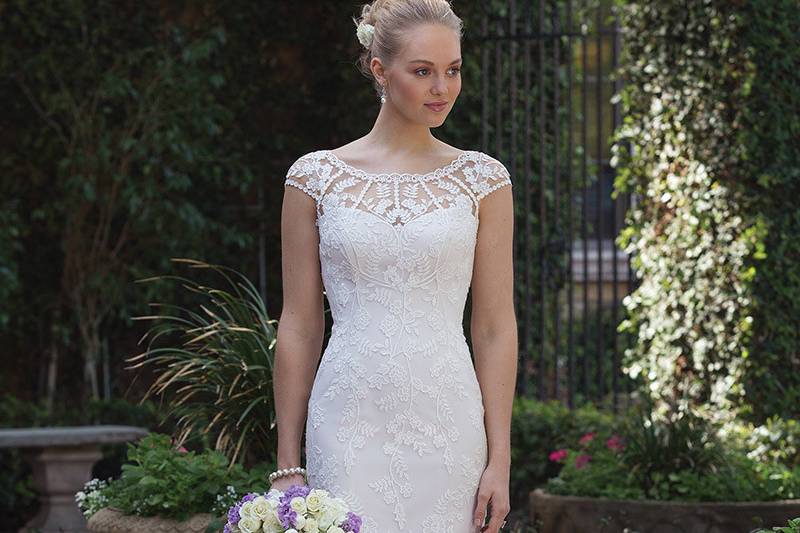 Sincerity Bridal	4018	<br>	Venice lace and appliques adorn this illusion Sabrina neckline and illusion back. The fit and flare skirt is accented by floating Venice lace and a finished scalloped trim lace. Buttons start at the top of the back and cascade to the bottom of the hem.