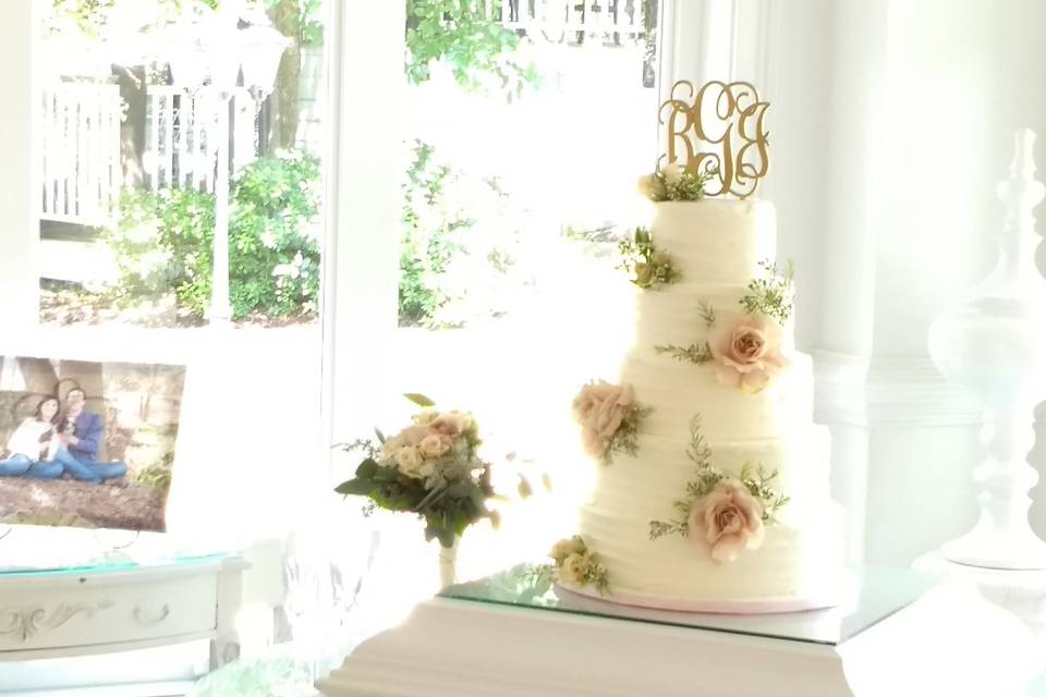 White wedding cake with soft pink flowers