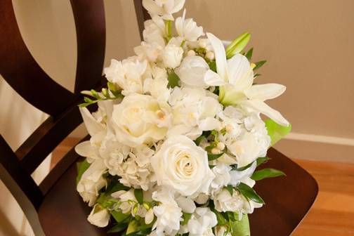 Cascade bouquet featuring roses, lilies and orchids. Photo by Innovative Photography.