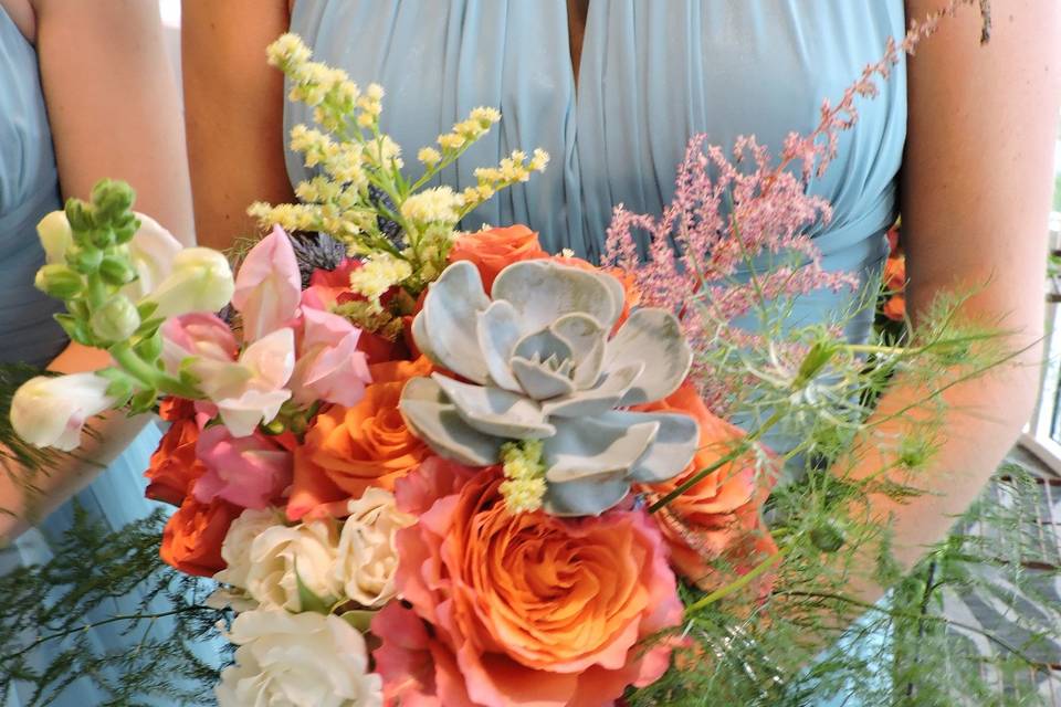 Free-form hand-tied bouquet including echeveria, garden roses, astilbe, snapdragons, and spray roses.