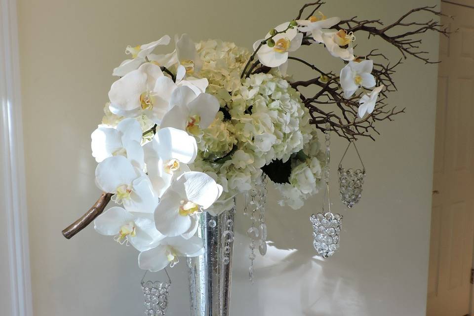 Add drama to your wedding with hydrangeas, orchids and hanging votives and crystals.