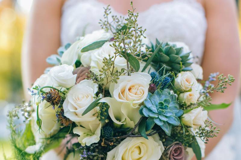 A grandmother's rosary provides a special touch to the handle of this bouquet featuring succulents. Photo by Zev Fisher