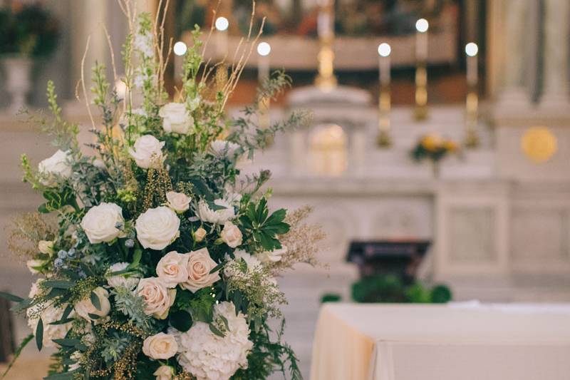 Soft colors in a gold urn flank the altar at the beautiful St. Cecilia's Parish in Boston.