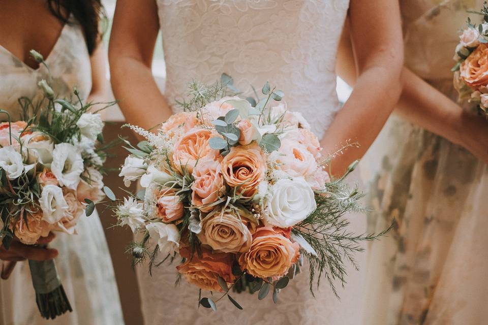 A bouquet of whites, peach and grays combined with ethereal touches compliment the bride's dress. Photo by Li Ward/Fat Orange Cat Studio photo