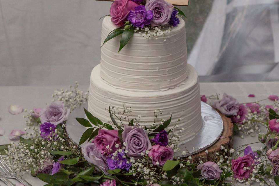 Cake flower accents in shades of Purple and Lavender, to include roses, carnation babys breath and staticeCake & Cookies : Little Emma’s CakeryPhotography by-http://samanthaonealphotography.com/2017/04/sofia-caleb-swan-wedding-private-estate-austin-county-texas/