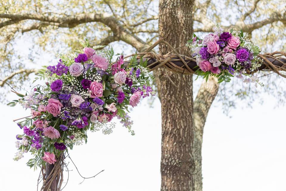 Spring floral arch in shades of Purple and Lavender, to include roses, carnation, stock, babys breath and staticePhotography by-http://samanthaonealphotography.com/2017/04/sofia-caleb-swan-wedding-private-estate-austin-county-texas/