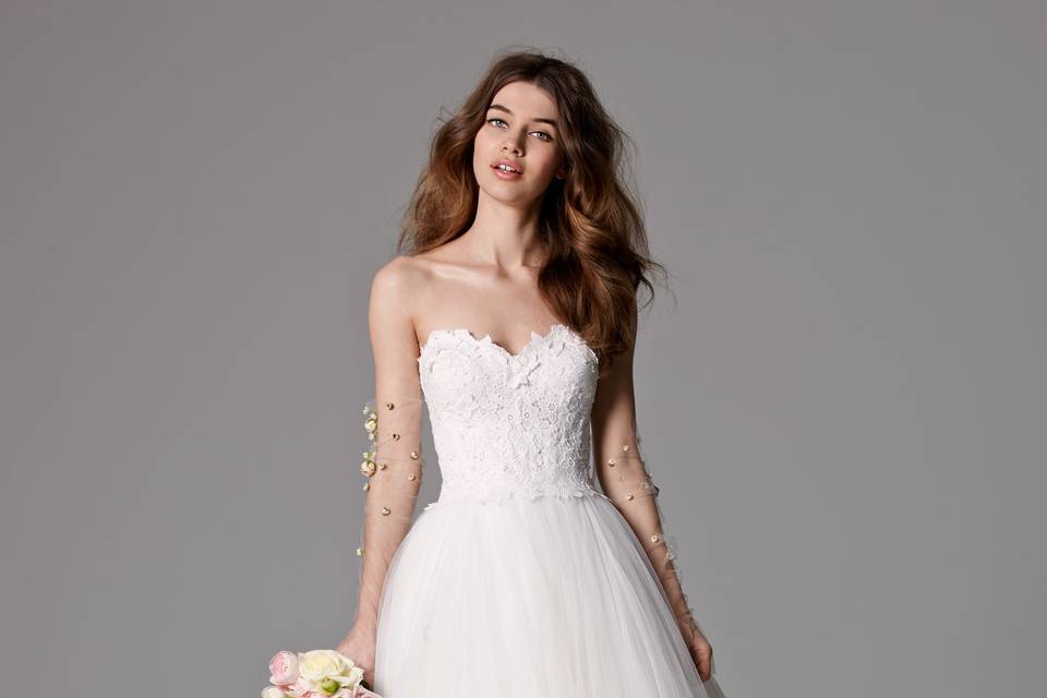 Style 8065B Edlin <br> The beauty is in the details with this strapless, Tulle ballgown that features rouched pattern work throughout the skirt and a sweetheart neckline. Shown with Lithia Belt style 8904B (sold separately). Sweep Train.