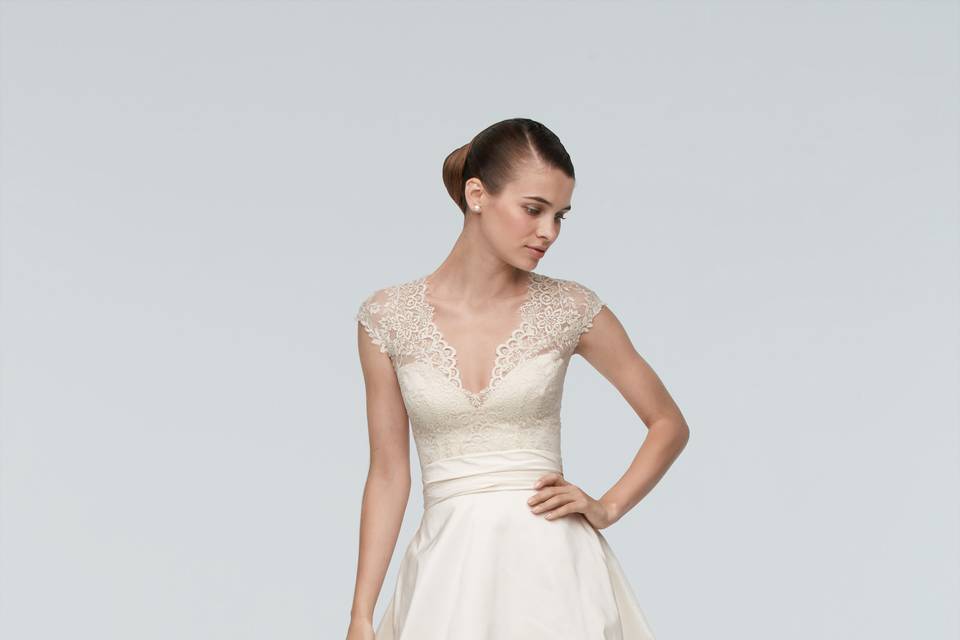 Style 9010B Georgia <br> Exquisitely crafted embroidered lace is the star of this vintage-inspired gown. It’s the perfect fit for the bride with a serious eye for detail. A stunning addition to our wedding collection, this dress showcases ivory Sanzani embroidered lace in a fit-and-flare silhouette with a dramatic sweep train. The sleeveless silhouette with V neckline delicately displays the bride’s collarbone and shoulders, while also serving as the ideal frame for a statement heirloom necklace.