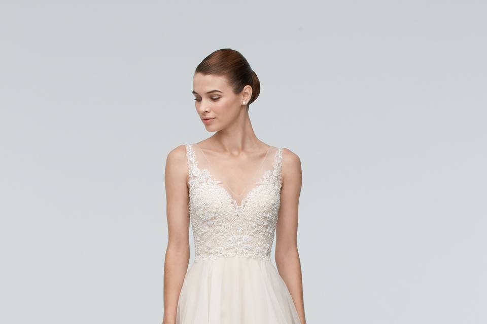 Style 9019B Oma <br> Our designers left no detail untended in this stunning ivory Adayln lace gown with champagne-colored stretch lining. From the delicately curving sweetheart neckline to the swirling chapel train, it’s a lovely addition to our wedding collection. The subtle drop waist will flatter all brides by elongating your torso and highlighting your curves. Feminine and romantic, this elegant dress fits a variety of wedding venues from an intimate chapel to an evening ceremony in the country. (And speaking of details, the lace-covered buttons add a thoughtful touch.) Shown with Ruthie Belt style 9903B (sold separately).
