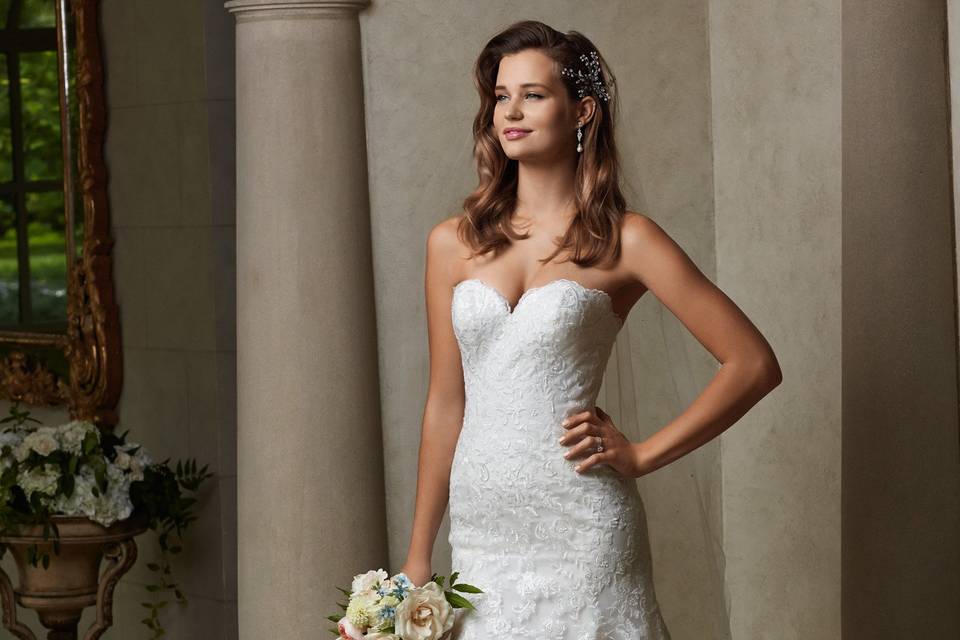 Style 14609 Holly <br> This soft net, fit and flare gown features beaded straps on illusion tulle, ruching that hugs every curve, and covered buttons on the back. Chapel train.