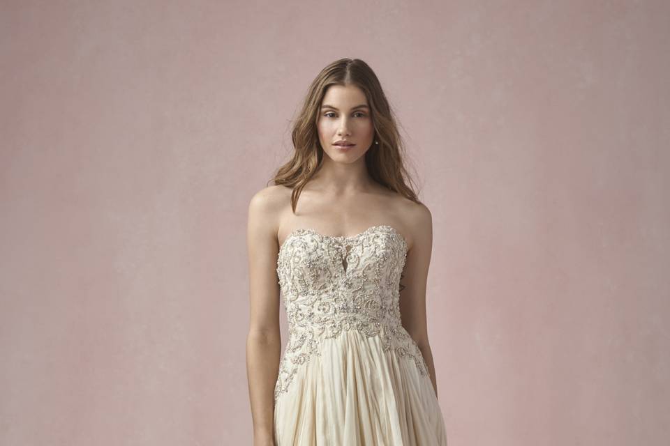 55127 Kiana <br> Sweet and feminine, this chantilly lace gown with scallop neckline features floral embellishments on the bodice. Puddle train.