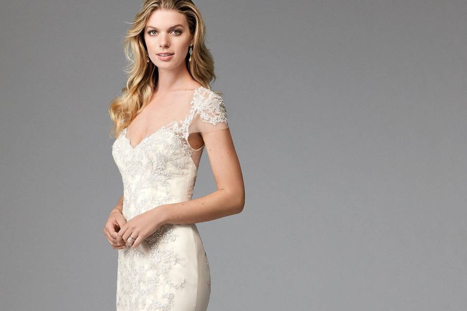 Della 1711B	<br>	Della speaks to Wtoo's signature soft and flowy style. Thoughtfully-placed Cybele Lace on the bodice and a graceful, Soft Netting skirt are perfectly accented with a velvet ribbon belt. Chapel Train. MSRP reflects beaded style. Also available unbeaded as style 17711P.