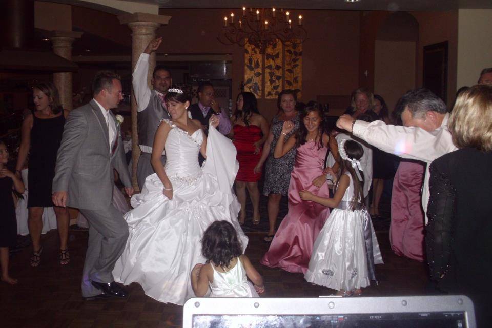 The couple dancing with guests