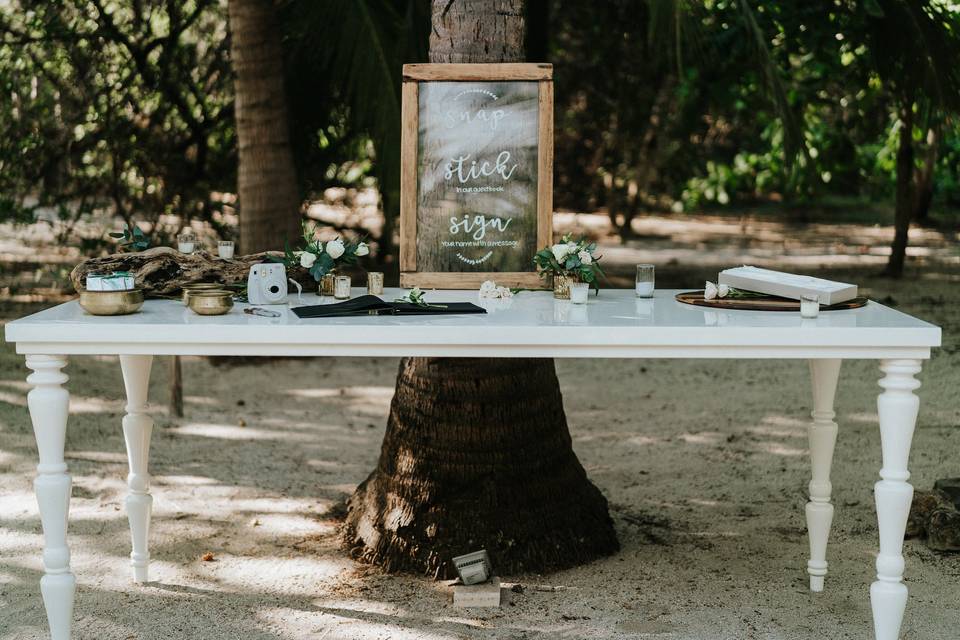 Welcome table with a personalized frame, polaroid, candles.