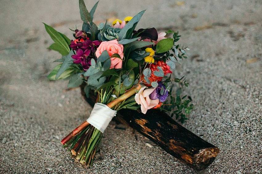 Bride bouquet with a pallet of greens, pinks, purples and splashed of yellow