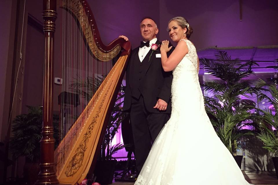 Newlyweds take a photo with the harp